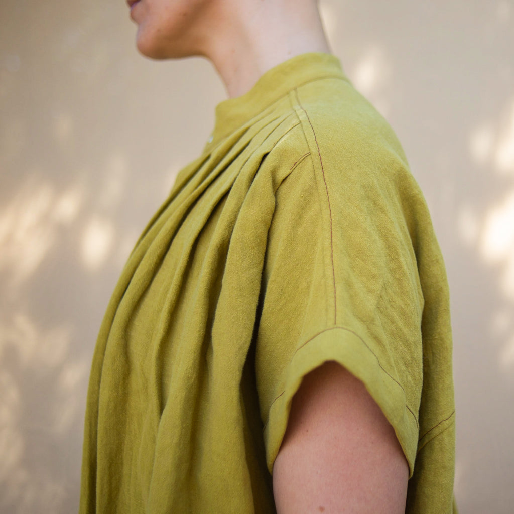 Close up showing details of the Pleats.  Linen, Asymmetrical Pleated Shirt - Chartreuse. Made in California, USA by Rebecca Rae Design Inc. Gender-Inclusive Clothing.